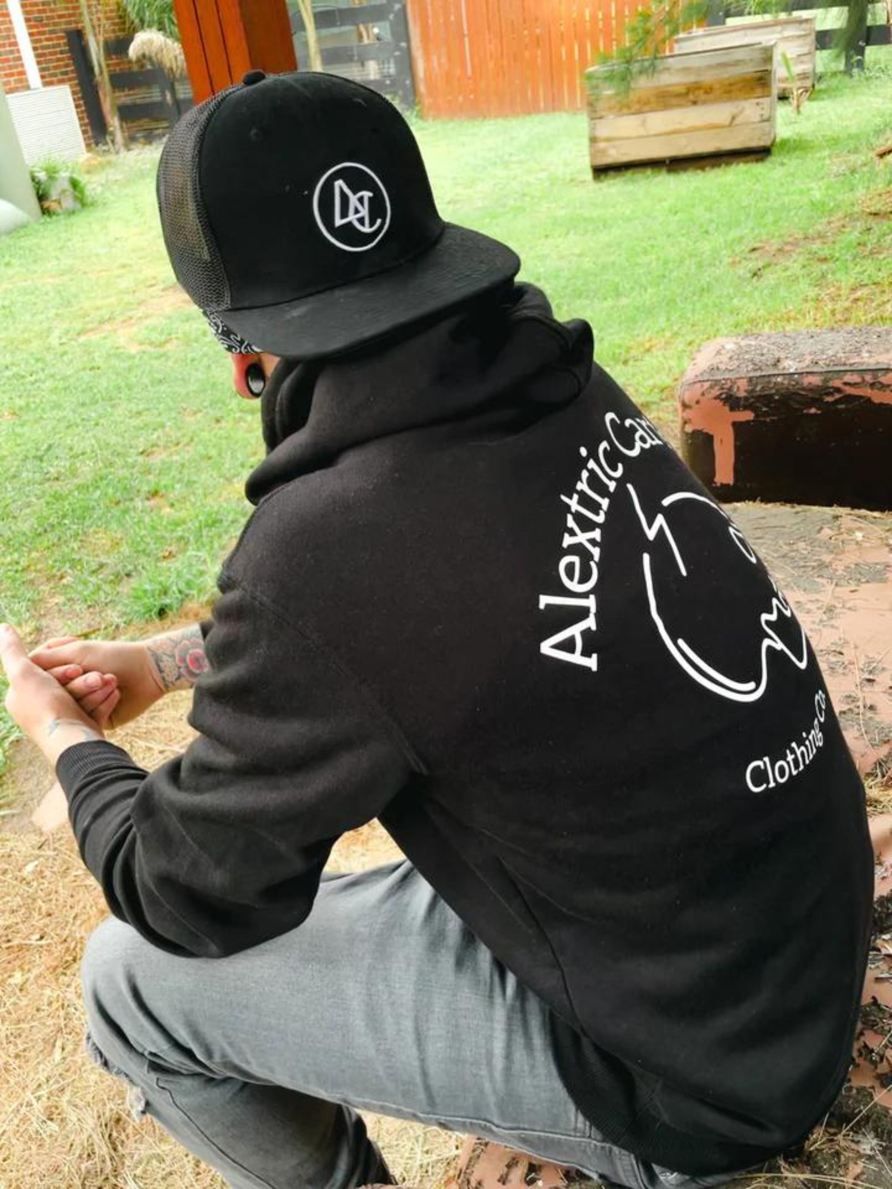 Black skull hoodie shown and black mesh hat