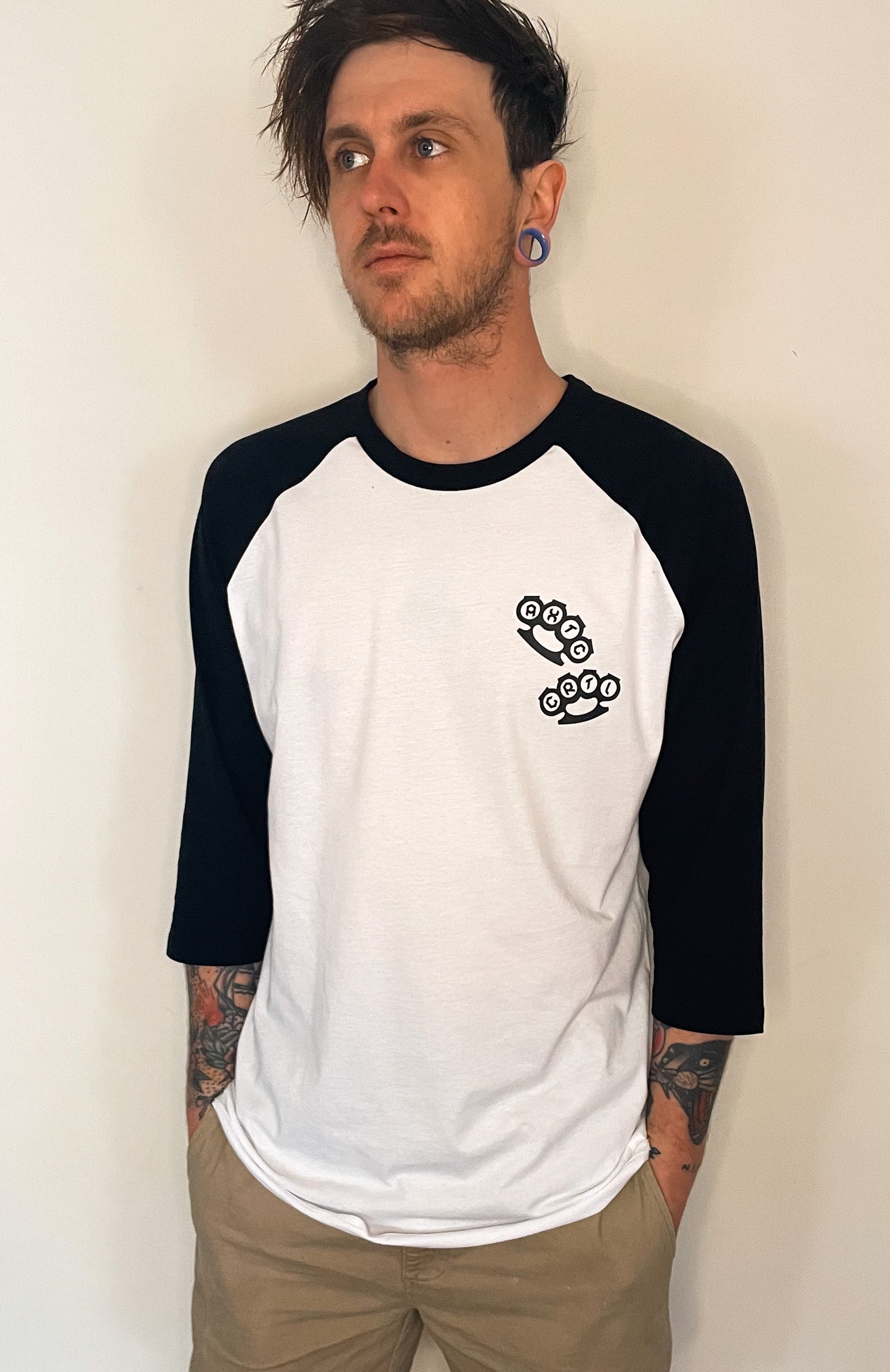 White with black sleeves baseball style top. Knuckle dusters design by Alextric Cartel