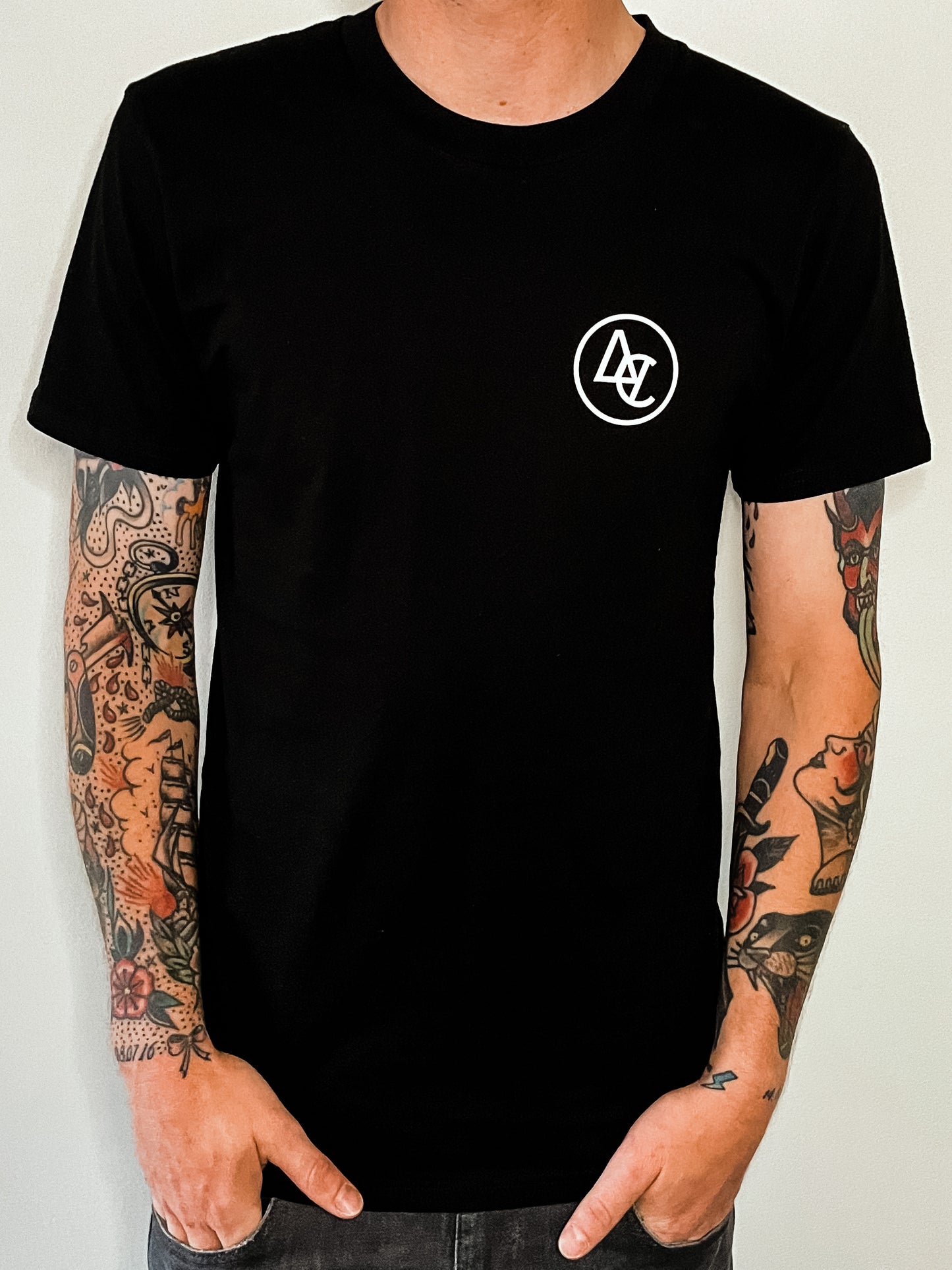 Black premium staple tee with white logo design