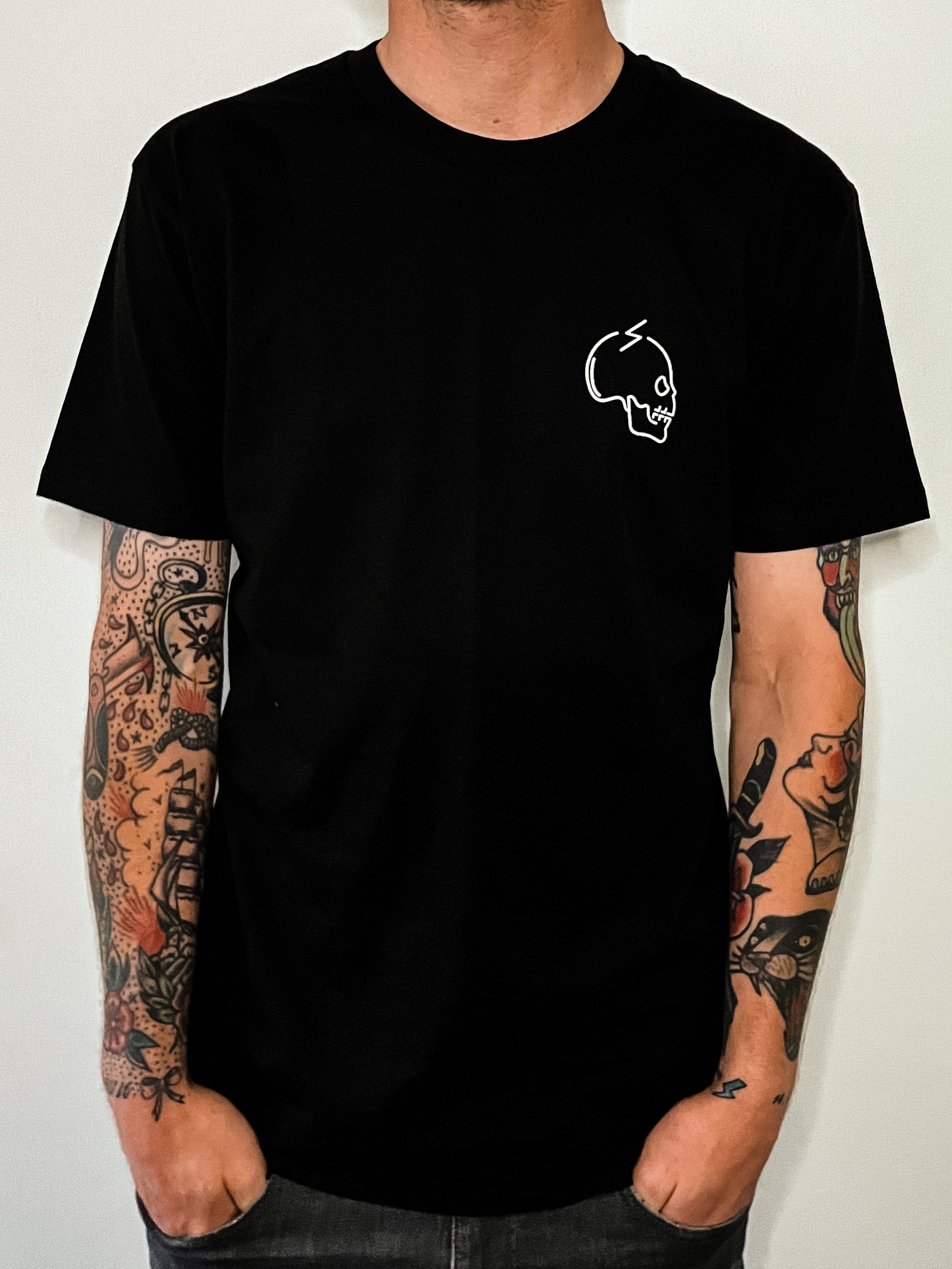 Front view of black graphic skull tee Alextric cartel